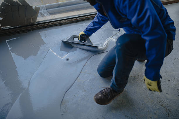 istock Skilled worker applying resin coating to floor 2223401019