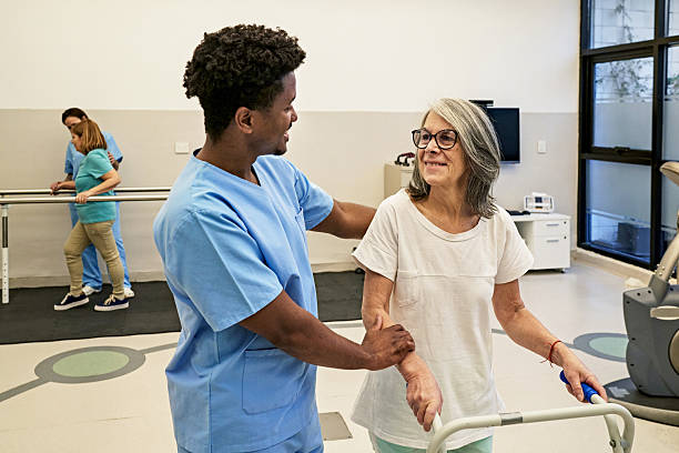 istock Physical therapists and patients working together in clinic 2223406099