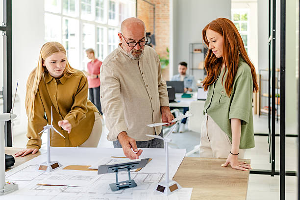 Collaboration in a Scandinavian office setting fosters innovative planning and development initiatives