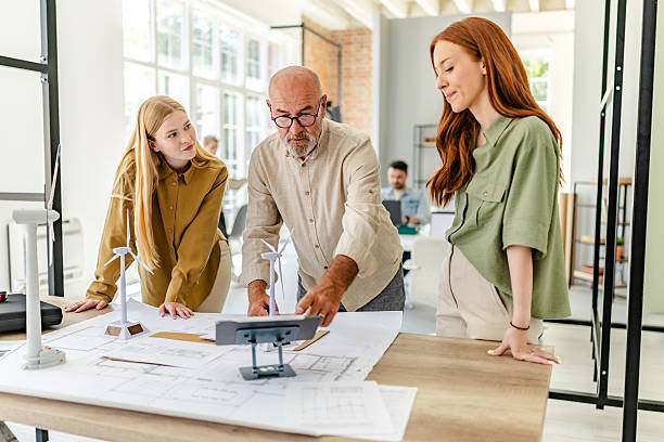 istock Collaboration in a Scandinavian style office as professionals discuss project plans and ideas 2223415195