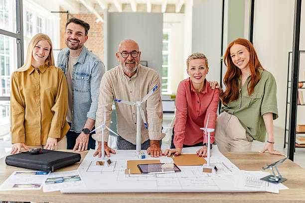 istock Collaborative team of professionals engaged in innovative planning for renewable energy solutions in a Scandinavian style office 2223416191