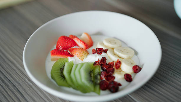 Yogurt with fruit salad on plate