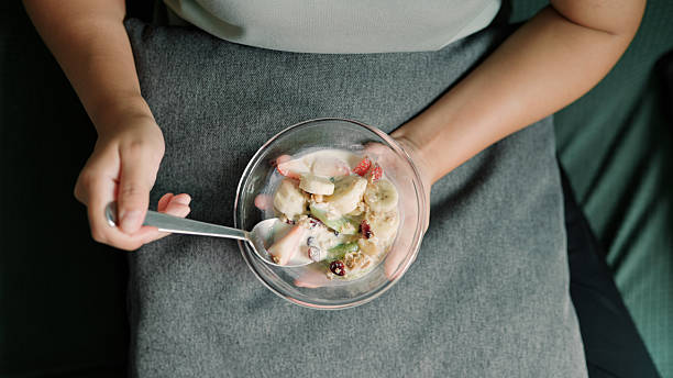 Asian woman eating milk with fruit