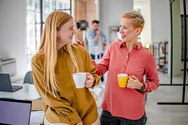 istock Collaboration in a Scandinavian office environment with professionals sharing ideas over coffee 2223420188
