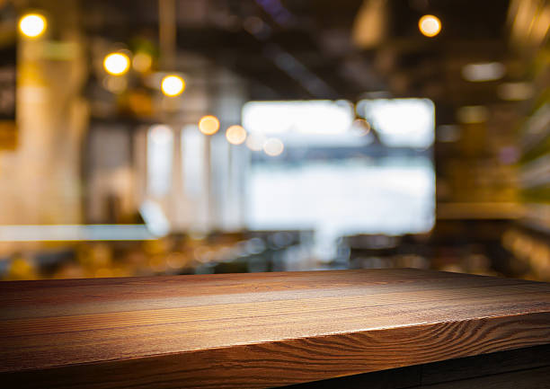 wooden table for placing products with a beautiful night restaurant backdrop.