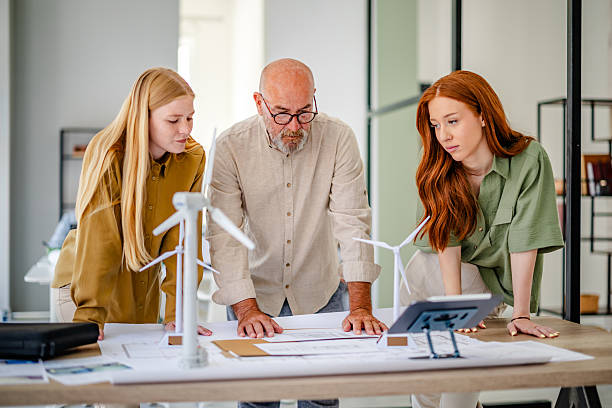 istock Collaborative planning session in a modern Scandinavian office with a focus on sustainable technology development 2223422410