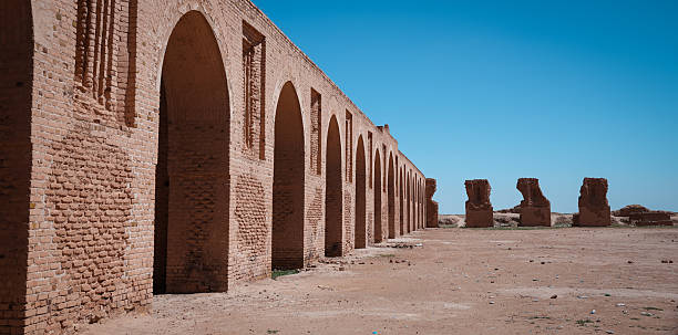 istock Historic architecture of Abu Dulaf showcases ancient brick arches under clear blue sky 2223422978