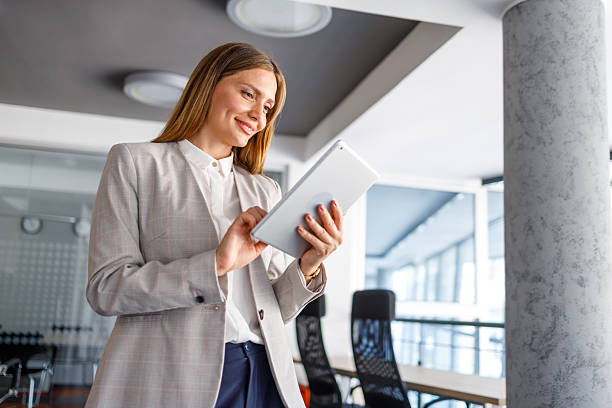 istock Young businesswoman using digital tablet in modern office 2223425068
