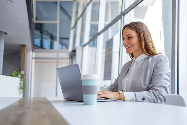 istock Professional woman working on laptop at office desk 2223425077