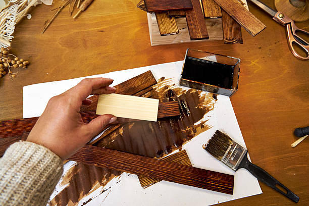 istock Creative workspace with stained wooden pieces, paintbrush, dried botanicals, and tools. A rustic collage takes shape with natural textures, warm tones, and handmade charm 2223425610