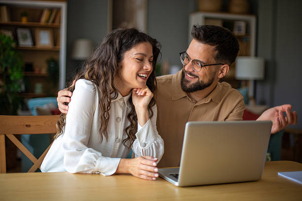 istock Happy couple working together on laptop 2223425723