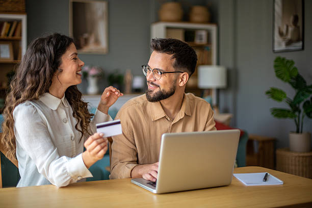 istock Happy couple managing finances together online 2223425864
