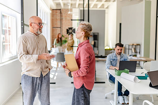 istock Professionals collaborate in a modern Scandinavian office to brainstorm innovative ideas and foster teamwork 2223426015