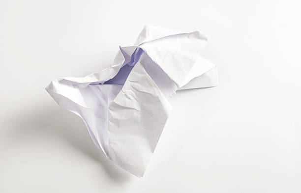 istock Crumpled white paper with a hint of purple creating an abstract form on a clean surface 2223426021
