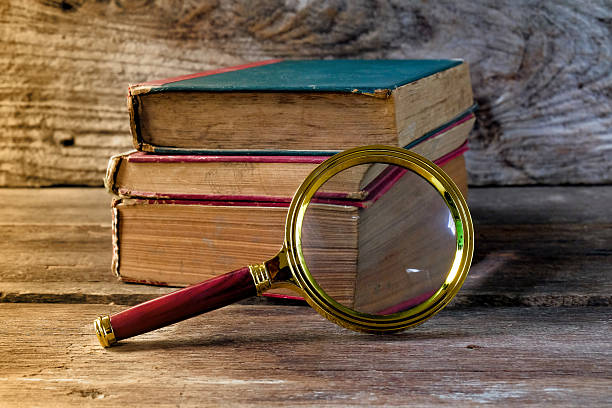 istock Vintage magnifying glass with old books. Concept for learn history. 2223426449