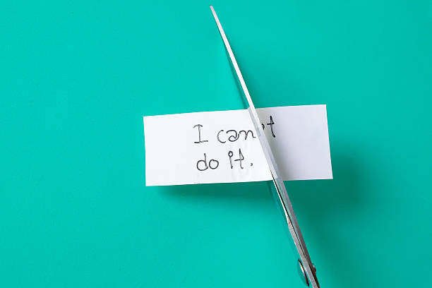 istock To cutting paper note with scissors to remove T word from I can't do it . 2223427248