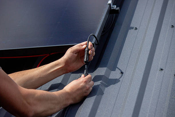 istock Technician Installing Solar Panels on Metal Roof 2223428101
