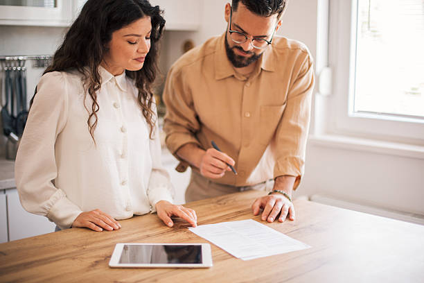istock Young adults discussing business documents at desk 2223428727