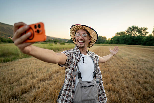 istock Smiling Farmer Taking a Selfie in the Field at Sunset 2223429039