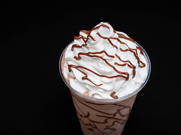 istock Chocolate milkshake served in a clear glass on a dark background. Isolated drink 2223429093