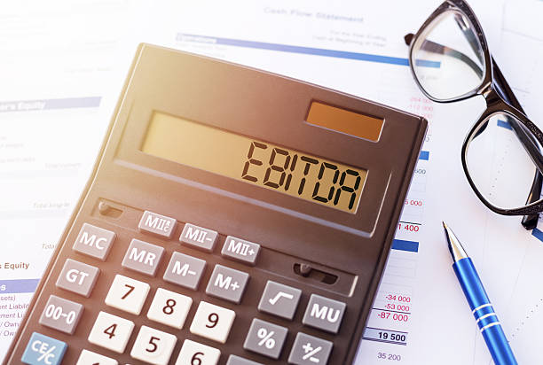 istock EBITDA (abbreviation of earnings before interest, taxes, depreciation and amortization) word written on calculator screen. Concept for your design. 2223429338
