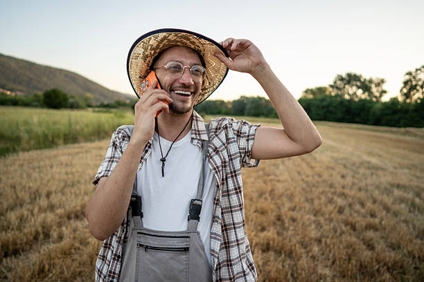 istock Smiling Farmer Speaking on Smartphone While Standing in Wheat Field 2223429477