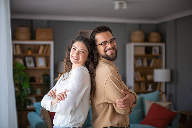 istock Confident young adults smiling in modern living room 2223430164