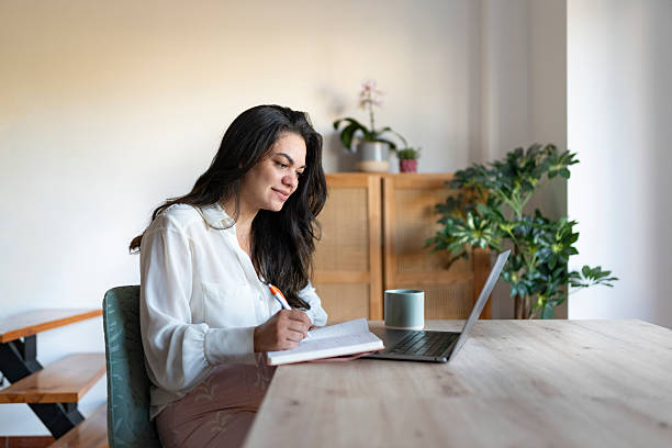 istock Business woman writing in notebook 2223432531