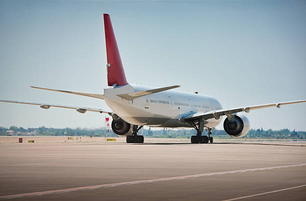Passenger aeroplane taxiing on the runway.