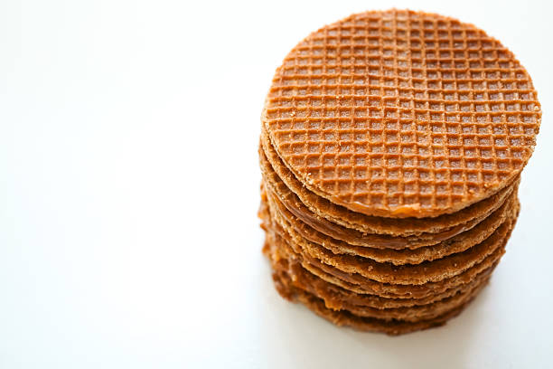 Dutch stroopwafels (Dutch caramel waffle) stacked on white background, top view