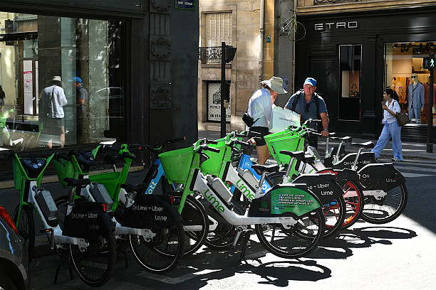 Paris, France - July 26, 2024: Velib Metropole Bicycle Sharing System Docking Station In Paris, Ile De France, People Walking