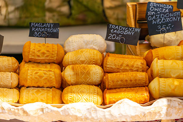 Traditional smoked cheeses (oscypek and other highlander varieties) stacked on a market stall