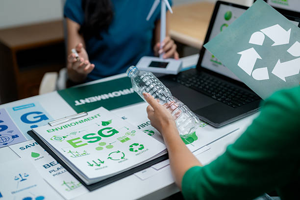 istock Professionals collaborate on environmental sustainability and recycling plans using digital and print resources 2223439520