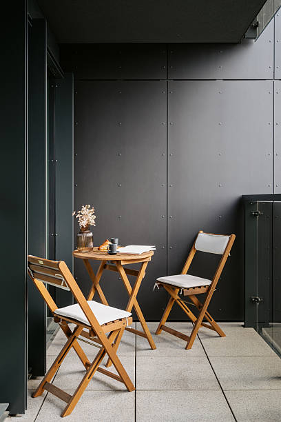 istock Modern balcony in loft style apartment with cozy seating for relaxation 2223440885