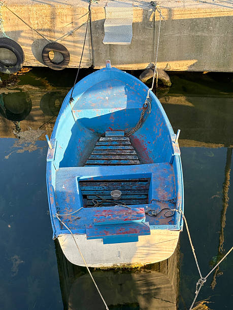 Fishing boat. Old small and wooden boat on coastline