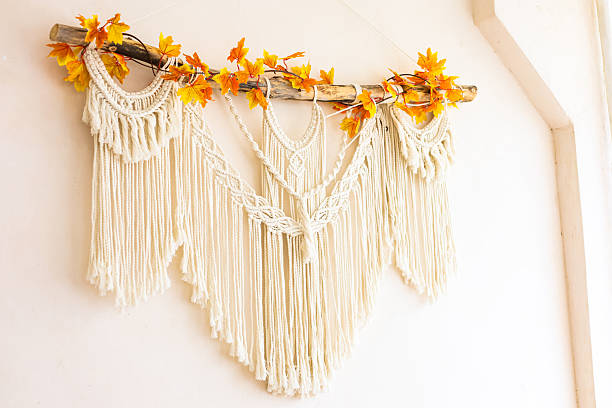 istock Macrame wall hanging decorated with autumn leaves in a cozy indoor setting 2223444587