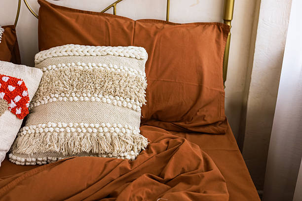 istock Decorated bed with cozy pillows and warm blankets in a tranquil bedroom setting 2223444686