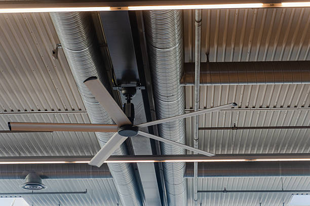 istock Ventilation. A working fan on the ceiling in a warehouse. 2223444731