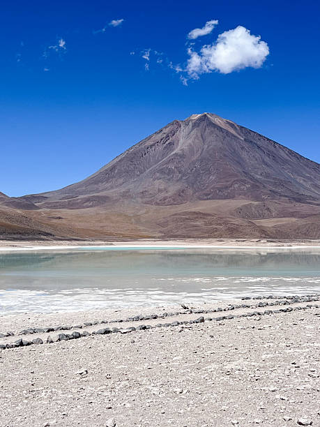 istock Volcanic Mountain Over Salt Flat Lake Landscape 2223445215