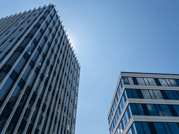 istock Modern glass office buildings against clear blue sky, low angle view 2223447632