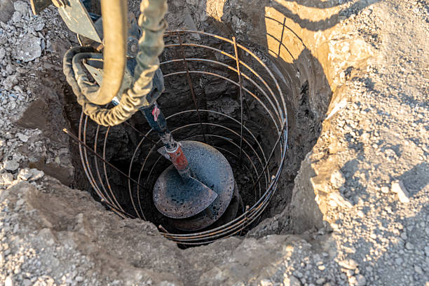 Construction equipment drilling vertical hole for a cast in place reinforced concrete pile foundation