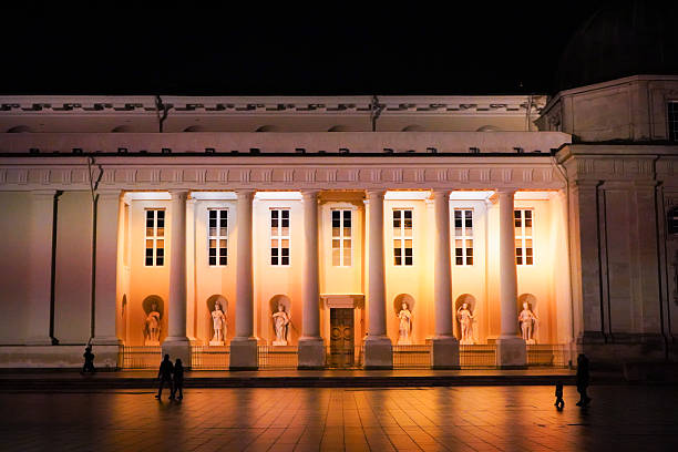 Close up of Vilnius Cathedral in night with  bright light reflecting on the wet ground, Vilnius, Lithuania