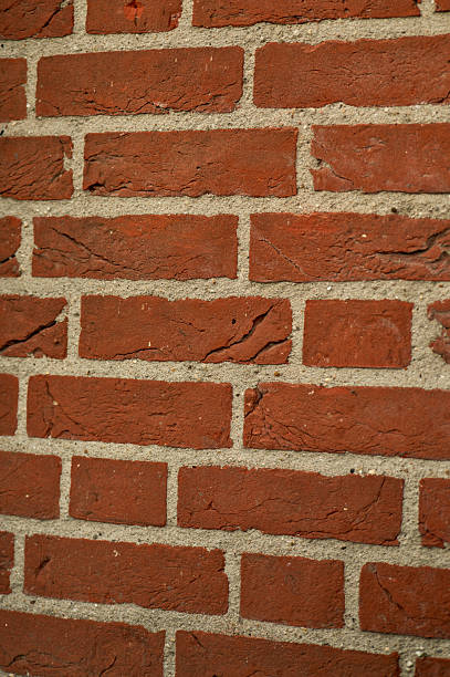 istock Close-up of a red brick wall showing deterioration and cracks 2223457429