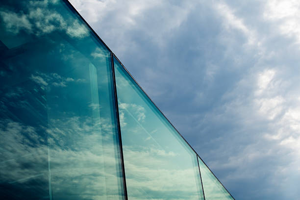 Part of glas building with reflections of the sky