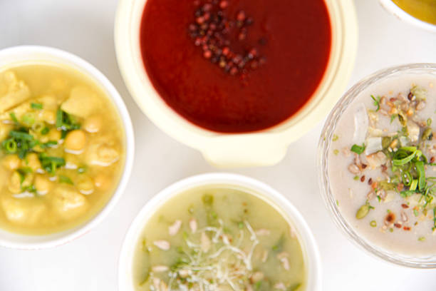 A comforting bowl of hot soup served with a spoon, ideal for cozy meals on cold days. The steam rising and rustic presentation evoke warmth, nourishment, and homemade goodness.
