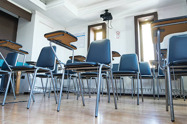 istock Empty modern classroom with individual desks and whiteboard 2223465056