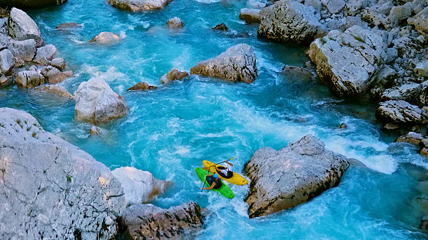 istock Kayakers navigate rapids, conquering the wild blue river 2223465805