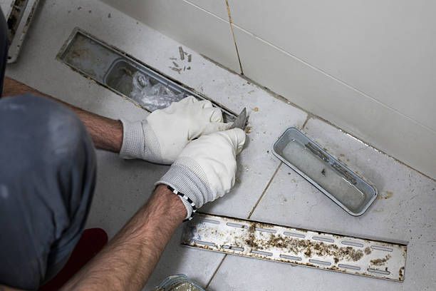 istock Professional worker repairing sewer and bathroom drain on floor 2223466095