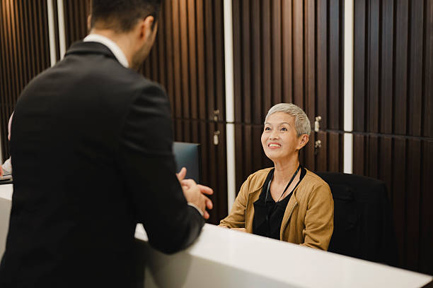 istock Businessman talking to receptionist 2223469590