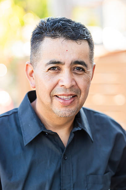 istock Headshot of a  smiling mature Hispanic man posing looking at camera 2223470545